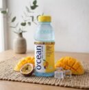 Ocean Fruit Drink Mango and Passion Fruit bottle with fresh mango and ice