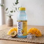 Ocean Fruit Drink Mango and Passion Fruit bottle with fresh mango and ice