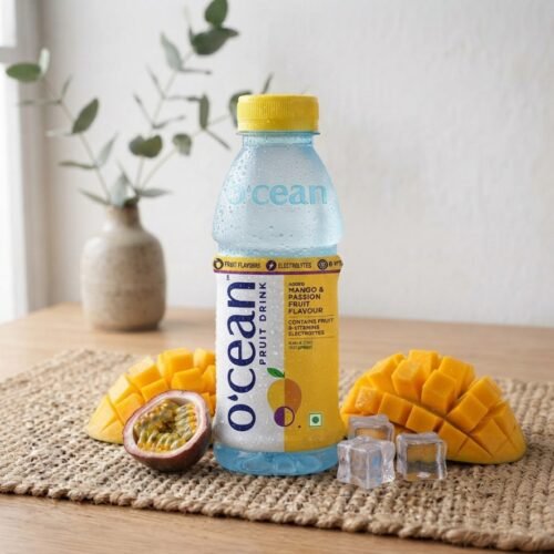 Ocean Fruit Drink Mango and Passion Fruit bottle with fresh mango and ice