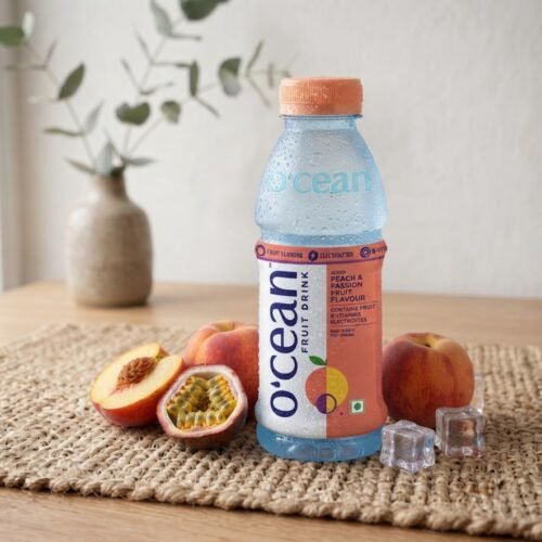 Ocean Fruit Drink Peach and Passion Fruit bottle with fresh peaches and ice